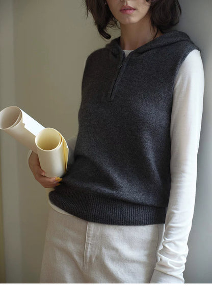 Close-up of dark gray Cozy Sleeveless Pullover Sweater showing hood, zip neckline and fine wool knit texture