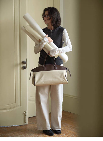 Full body look of dark gray Cozy Sleeveless Pullover Sweater paired with wide-leg pants and layered top for casual styling