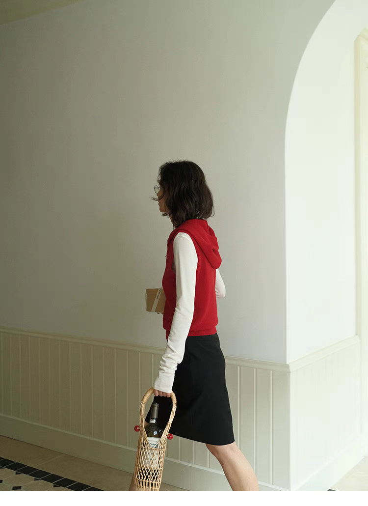 Side profile of red Cozy Sleeveless Pullover Sweater with hood, showcasing clean silhouette and sleeveless design