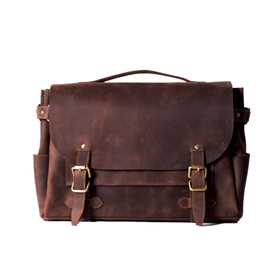 Front view of dark brown crazy horse leather satchel with brass buckles and flap closure.
