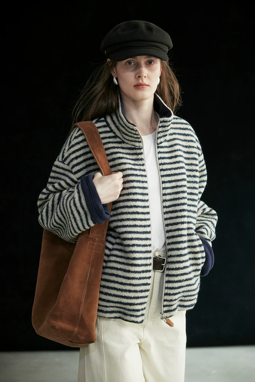 Cream/Navy Stripe oversized zip jacket worn open, showing the navy fleece lining at the collar