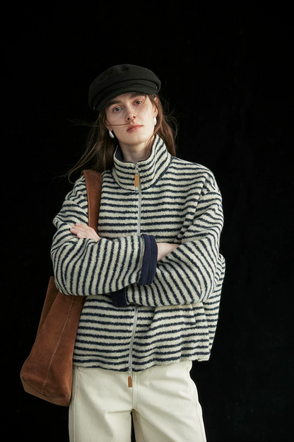 Cream/Navy Stripe wool-blend jacket zipped to the stand collar, with rolled navy fleece cuffs