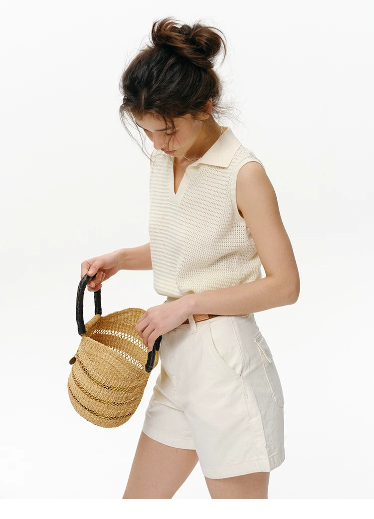 Side view of Cream openwork knit polo top showing sleeveless armhole and relaxed body