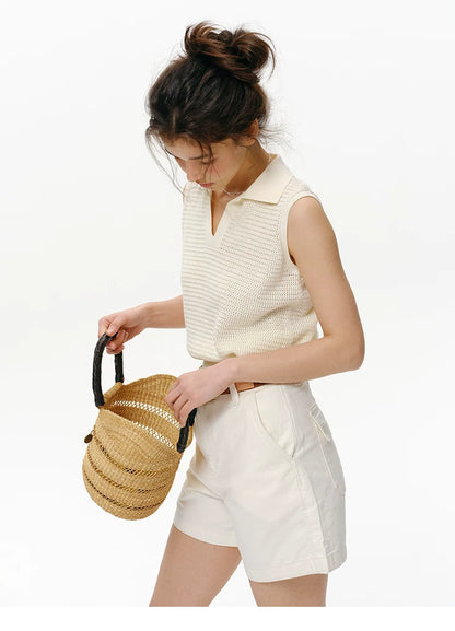 Side view of Cream openwork knit polo top showing sleeveless armhole and relaxed body