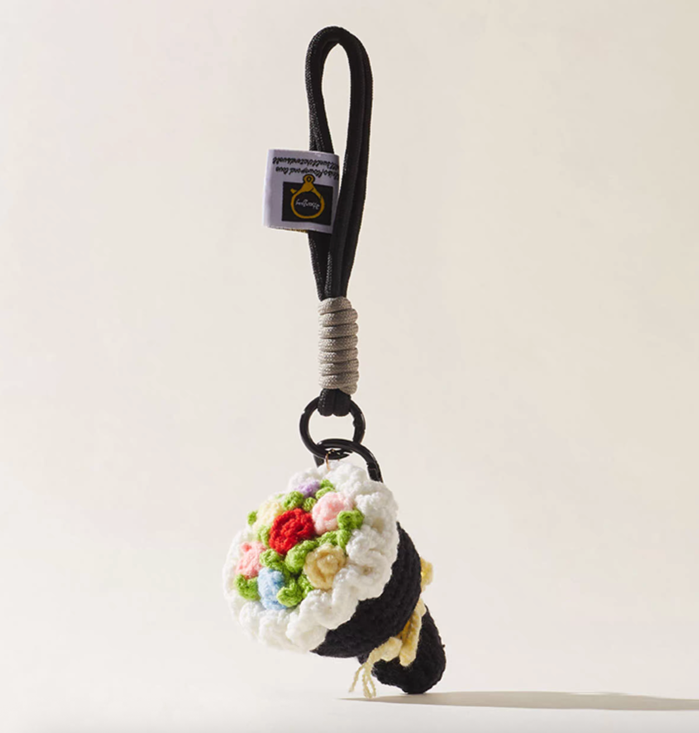 Black crochet flower bouquet keychain with multicolor roses.