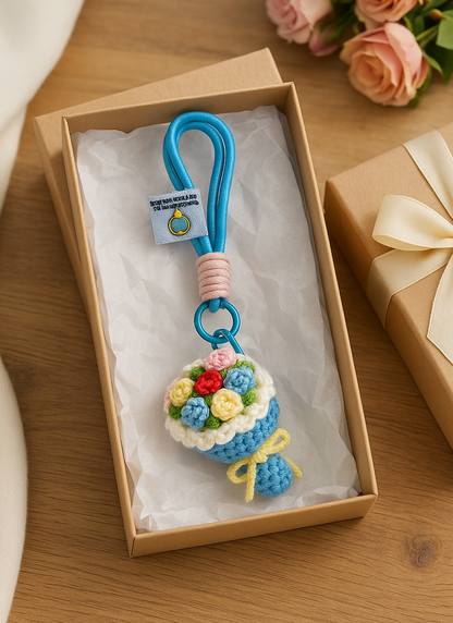 Handmade crochet flower bouquet keychain in blue with rope loop, displayed inside a gift box with ribbon, perfect for gifting.
