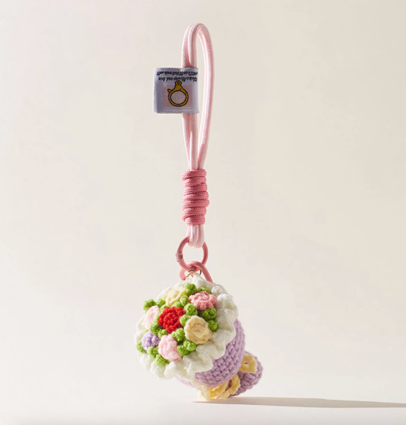 Lilac crochet flower bouquet keychain with pink rope loop.