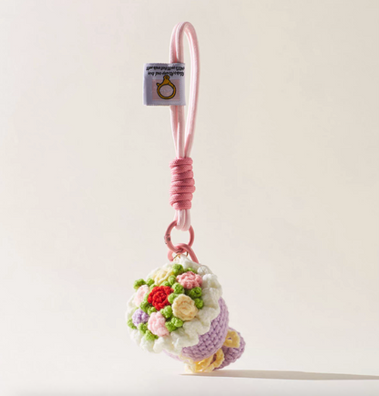 Lilac crochet flower bouquet keychain with pink rope loop.