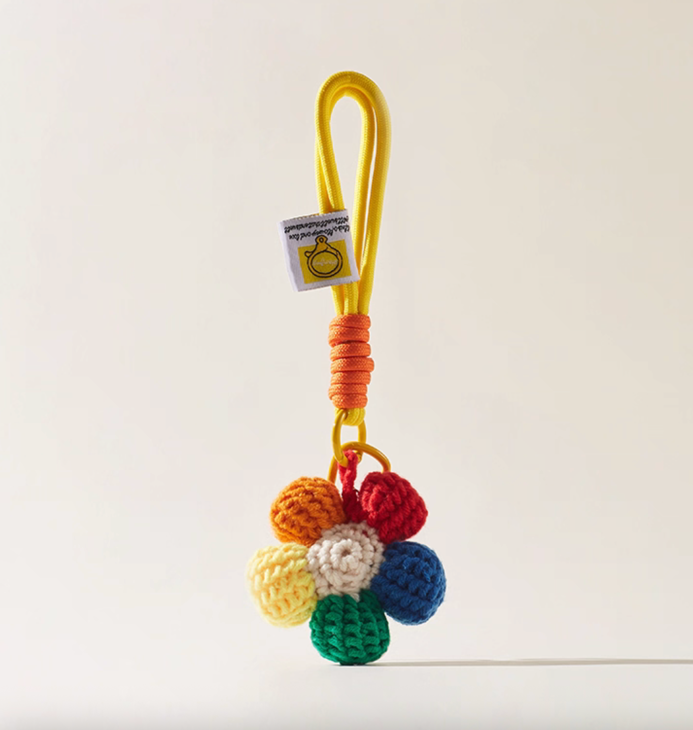 Handmade crochet flower keychain with yellow rope loop, multicolor daisy charm.