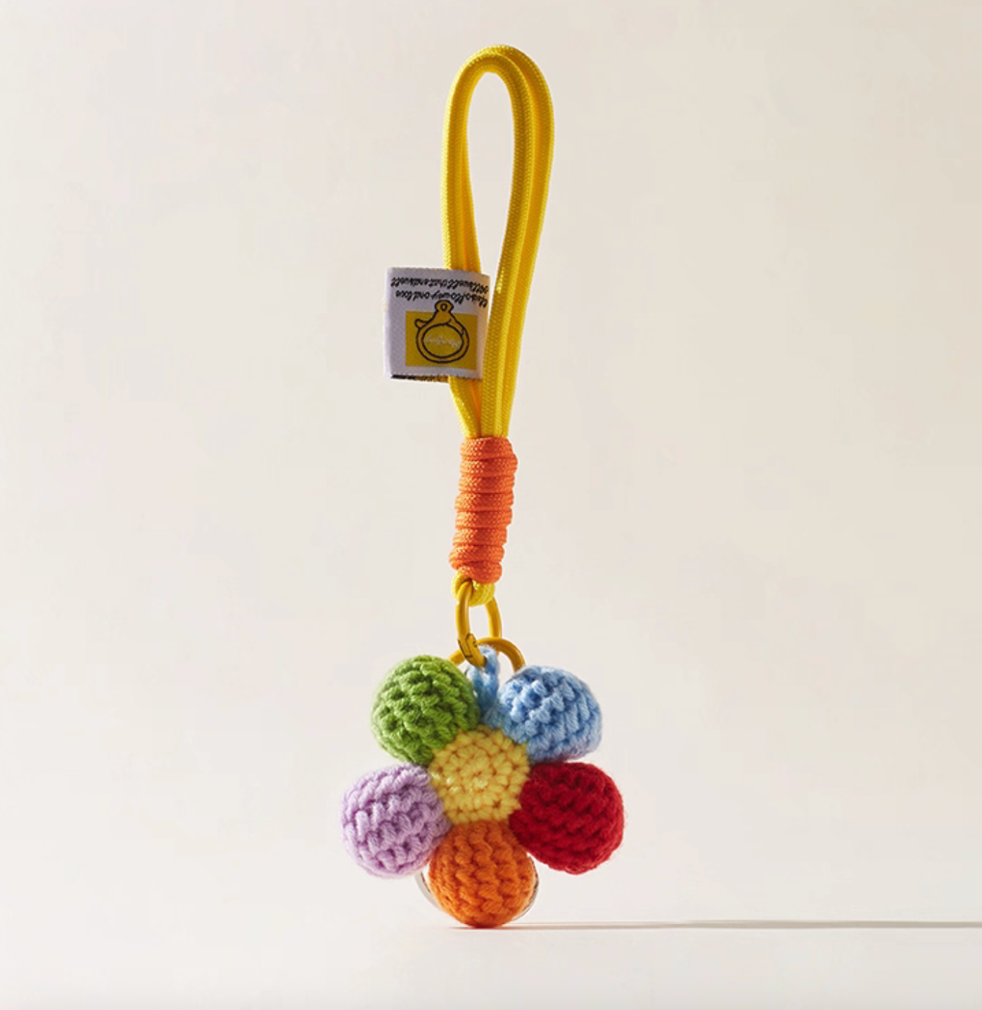 Pastel crochet flower keychain with multicolor petals, cottagecore style.