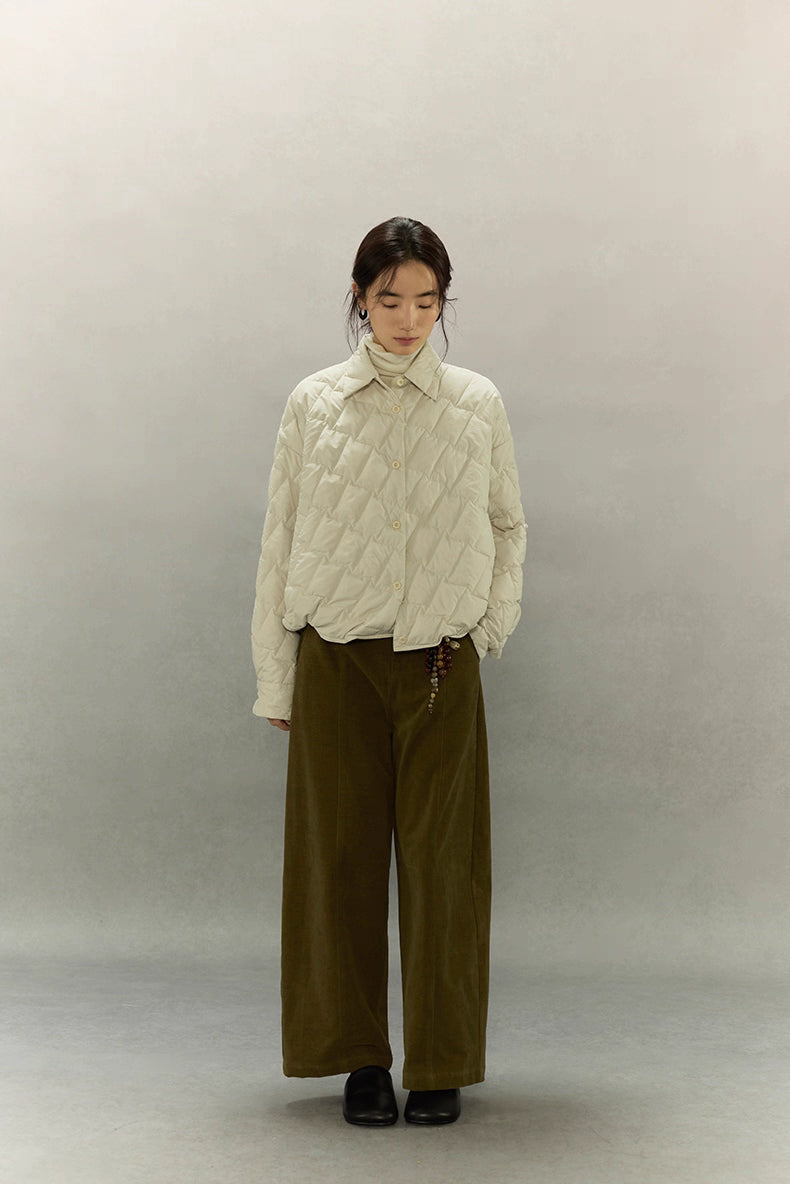 Front view of cream beige cropped goose down shirt jacket with relaxed fit and diamond quilting.