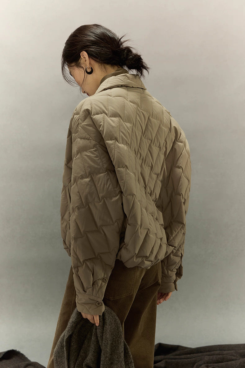 Back three-quarter view of khaki brown cropped quilted goose down shirt jacket showing textured quilting pattern.