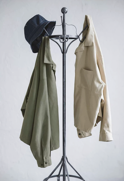Light green and light khaki Cuban collar shirts hanging with denim hat.