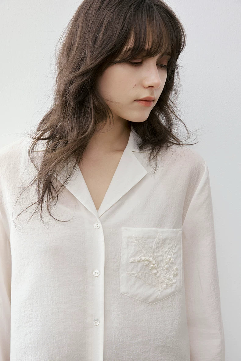 Close-up of ivory Cuban collar shirt notched collar and pocket