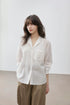 Front view of ivory Cuban collar shirt with embroidered pocket, standing pose