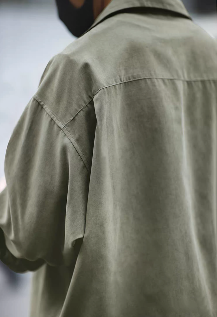 Rear view of light green Cuban collar overshirt showing relaxed cut.