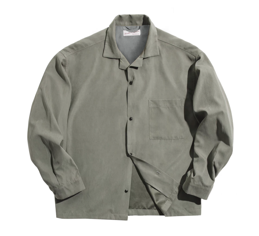 Men’s Cuban collar shirt in light green, peached texture flat lay.