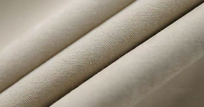 Close-up of light khaki Cuban collar shirt fabric texture.
