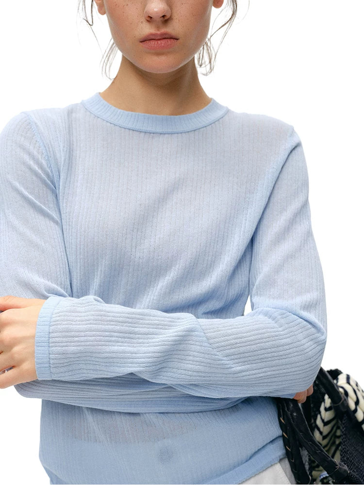 Close-up of powder blue cupro-silk ribbed knit top neckline and sleeve