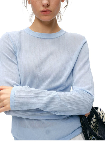 Close-up of powder blue cupro-silk ribbed knit top neckline and sleeve