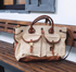 Beige canvas and brown leather weekender tote on wooden bench outdoors