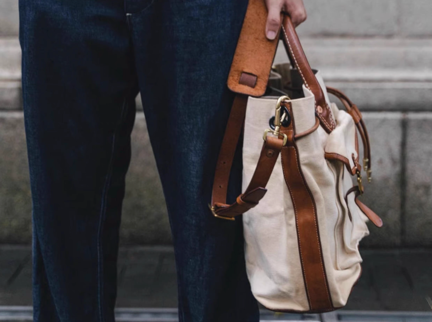 Side profile showing leather strap and solid brass fittings of canvas tote