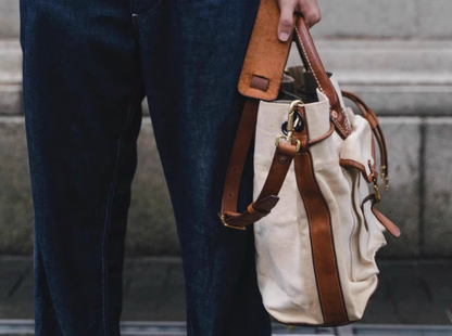 Side profile showing leather strap and solid brass fittings of canvas tote