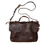 Dark brown full-grain leather messenger bag with long shoulder strap, flat lay on white background