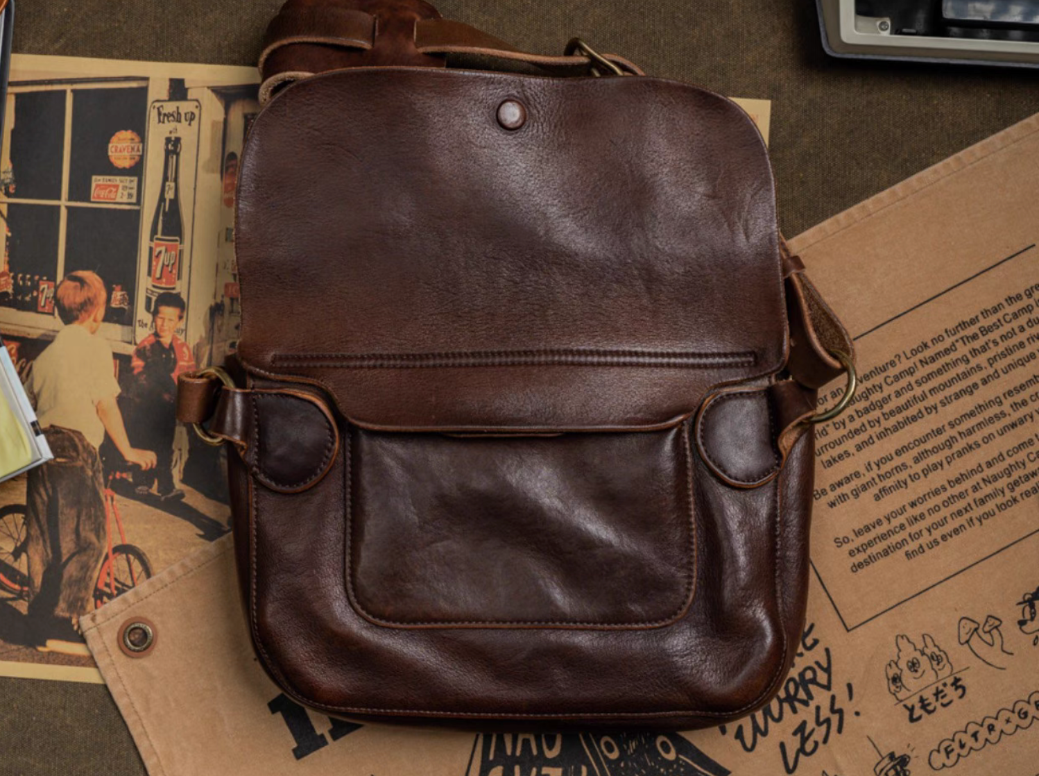 Back view of dark brown Italian leather satchel showing exterior pocket and side straps