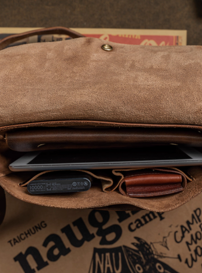 Inside view of vintage Italian leather bag showing compartments with power bank and wallet