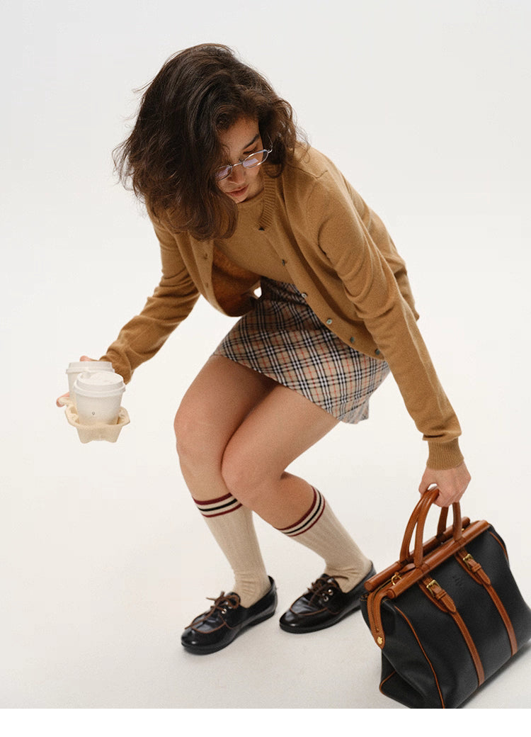 Camel Brown merino wool twin-set in motion, cardigan drape shown while picking up items