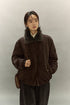 Front close-up of model wearing dark coffee brown sherpa-collar down jacket with crossbody bag