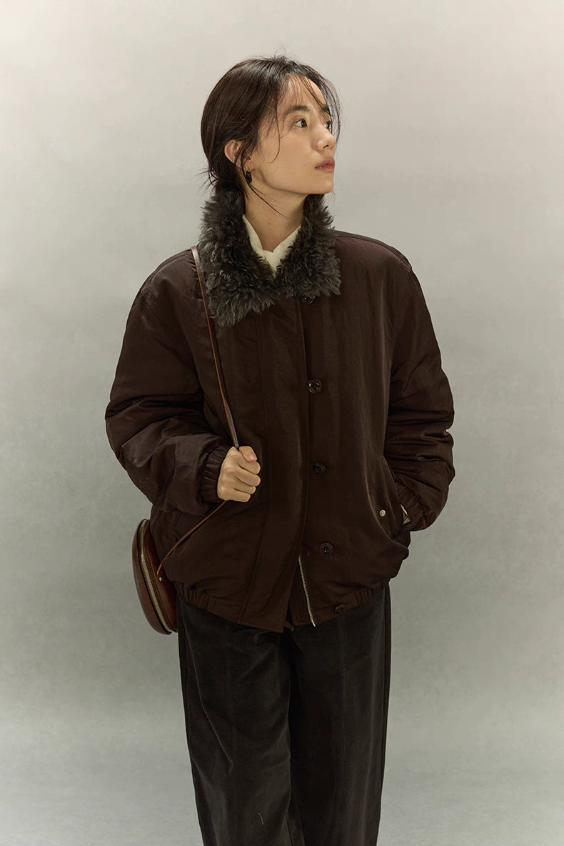 Model looking up while wearing dark coffee brown sherpa-collar down jacket front view