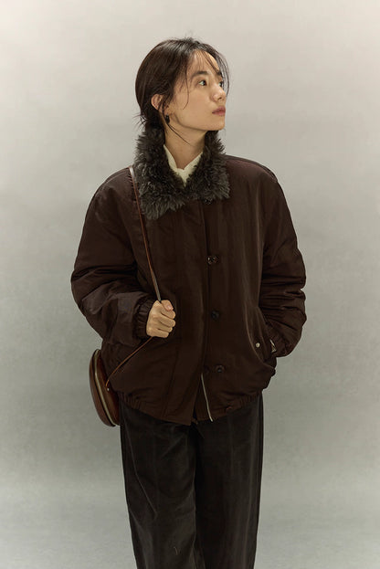 Model looking up while wearing dark coffee brown sherpa-collar down jacket front view