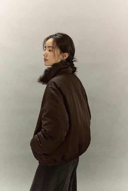 Side-back profile of dark coffee brown sherpa-collar down jacket showing relaxed fit