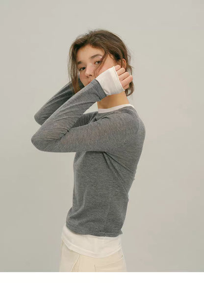 Heather Gray fine-spun wool slim top, side profile with raised arm