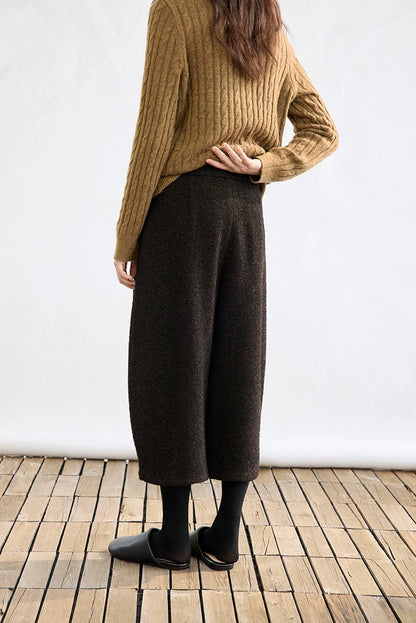 Back view of Dark Brown bouclé cropped trousers with a relaxed, slightly cocoon leg