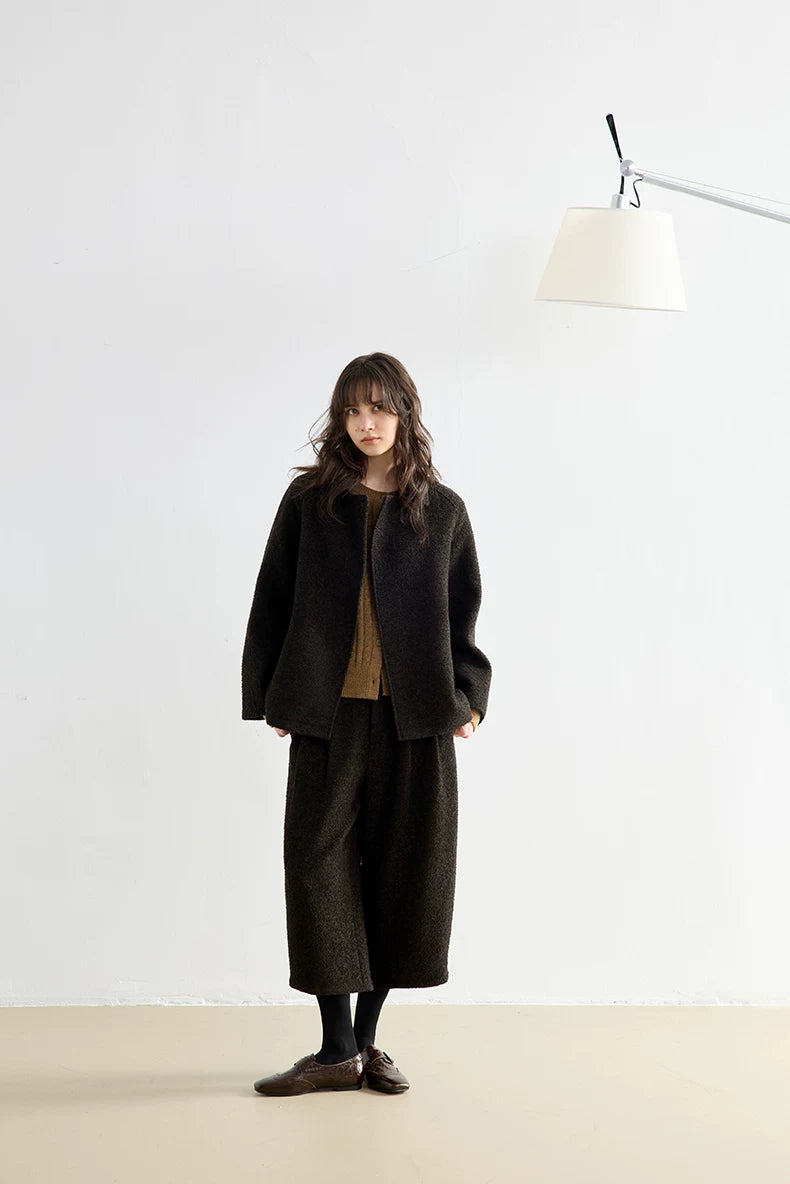 Full-length front view of a Dark Brown bouclé jacket and cropped pleated trouser set