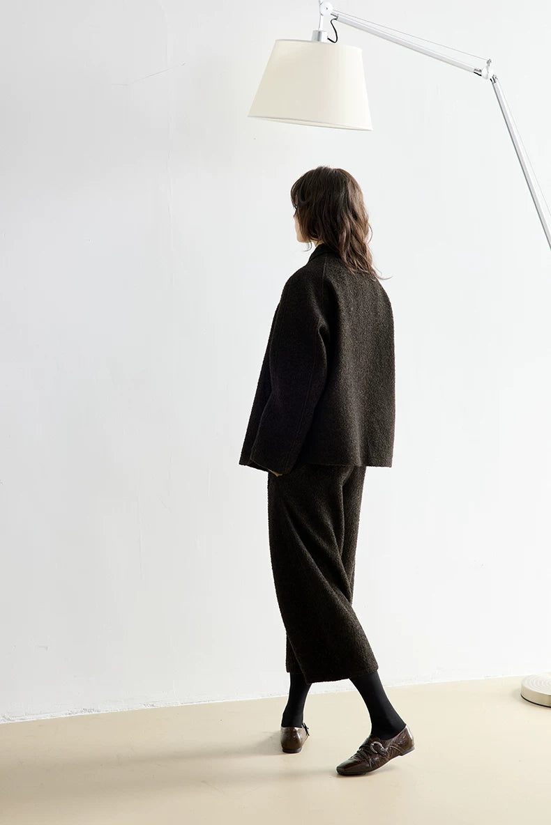 Side-back view of a Dark Brown bouclé jacket and cropped trouser set in motion