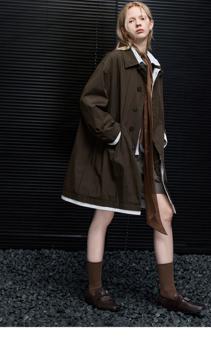 Full-length side view of a Dark Brown mac coat with point collar, button front, and white-trimmed hem
