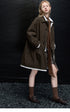 Full-length side view of a Dark Brown mac coat with point collar, button front, and white-trimmed hem