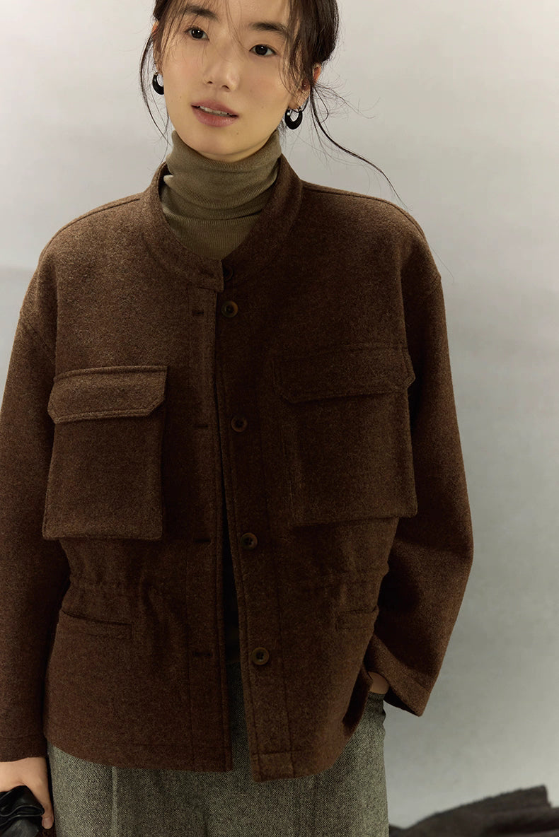 Three-quarter front view of woman in dark coffee alpaca wool field jacket over olive turtleneck
