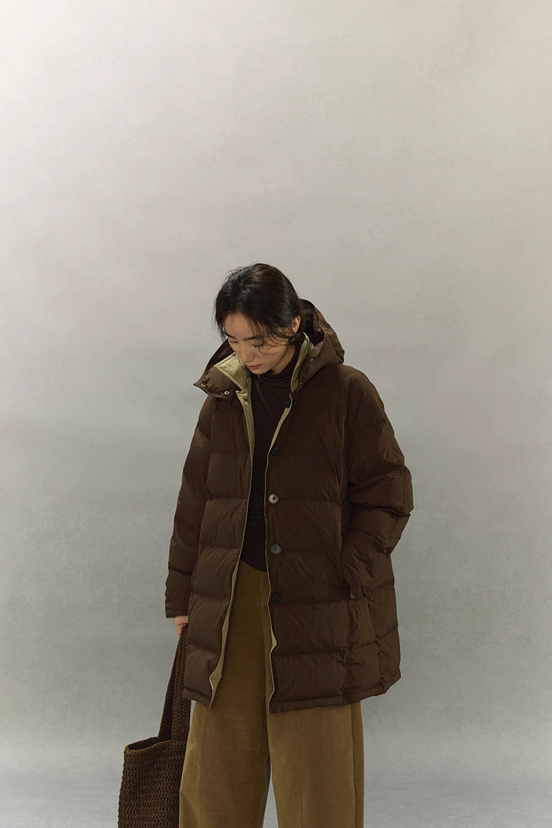 Full length outfit with dark coffee brown down coat styled with wide leg pants and knit tote