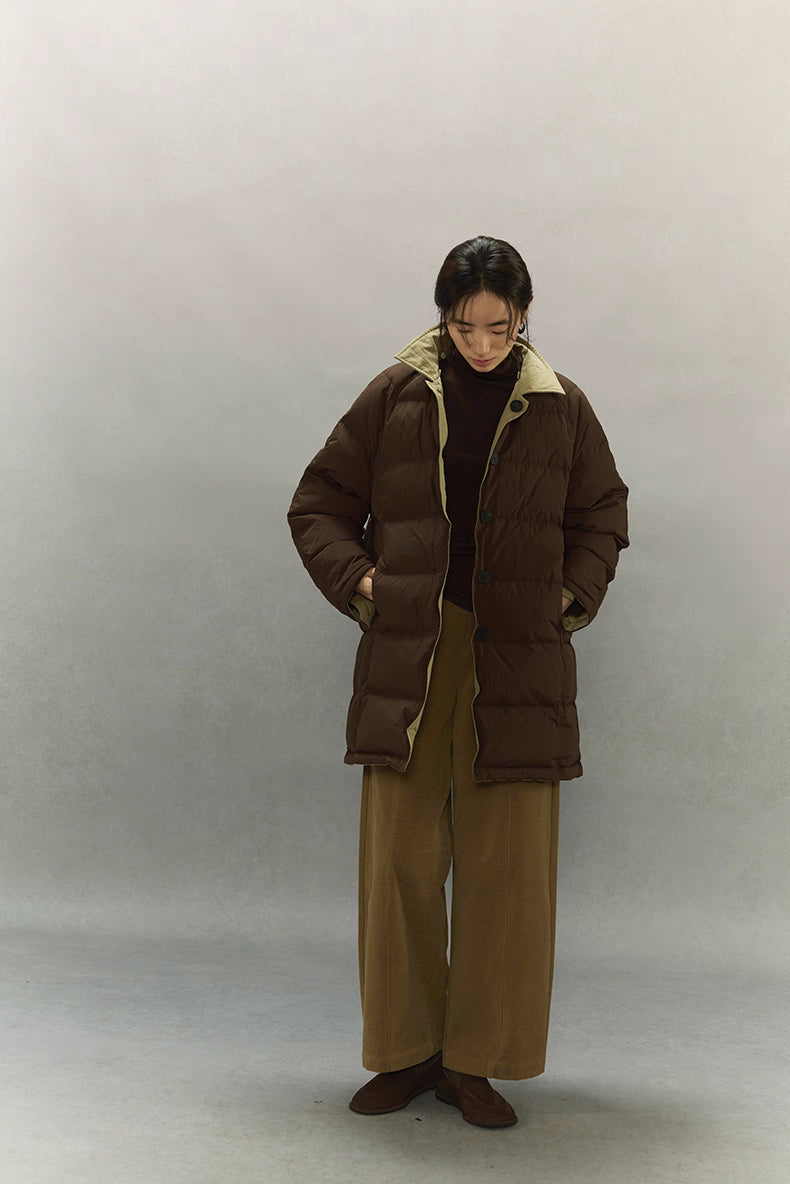 Women’s dark coffee brown down coat worn open to show contrasting khaki lining and relaxed fit