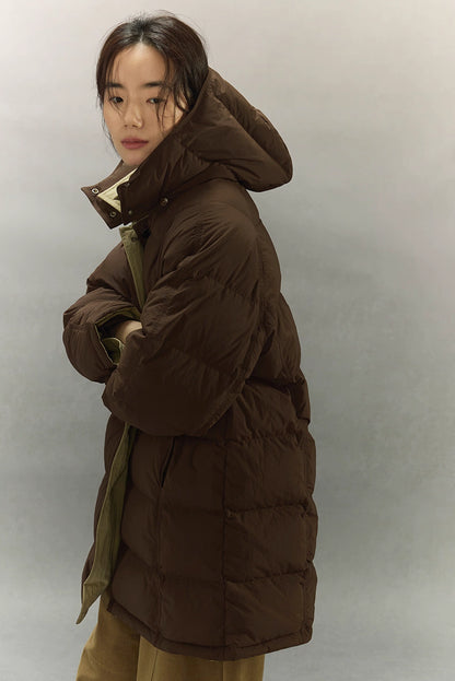 Side profile of women’s dark coffee brown puffer coat with hood and soft goose down quilting