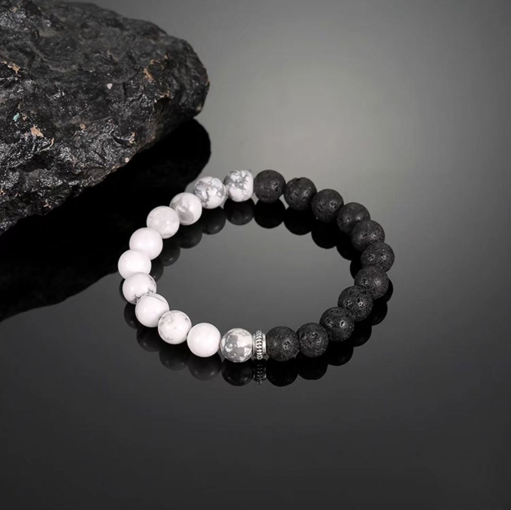 Day and night cracked lava stone bracelet with black lava beads and white cracked stone beads in balanced half-and-half design