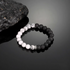 Day and night cracked lava stone bracelet with black lava beads and white cracked stone beads in balanced half-and-half design