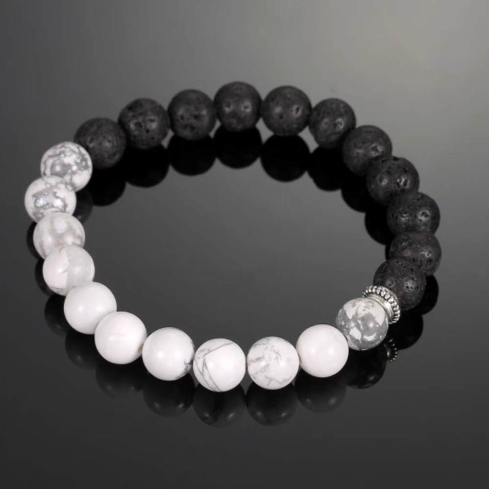 Close-up of cracked lava stone bracelet featuring black porous lava beads and white cracked stone beads with strong contrast