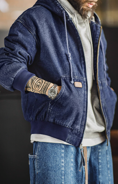 Side lifestyle shot with hand in pocket highlighting relaxed fit and rib hem.