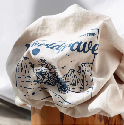 Desert Rider Graphic Cotton Tee Cream White folded view showing motorcycle desert graphic print and soft cotton fabric